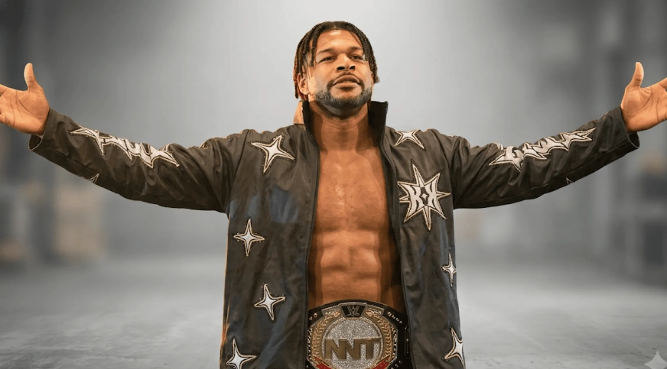 Kevin Knight standing with arms wide open, wearing his signature black zip-up jacket adorned with white and gold glittered star graphics across the sleeves and chest.