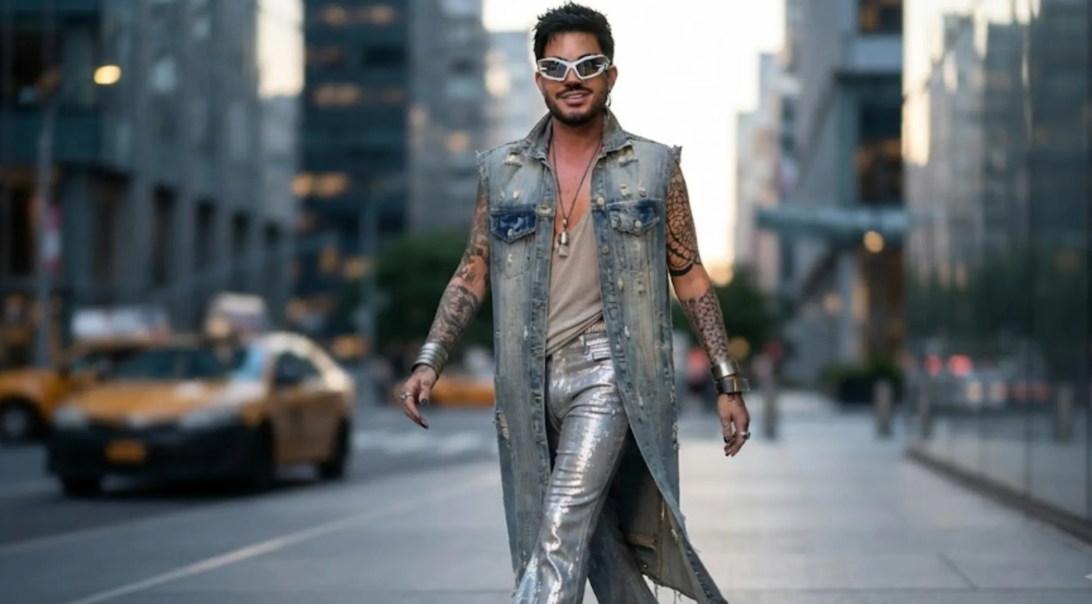 Adam Lambert NYC 2026 light blue distressed sleeveless long denim duster coat with raw-cut armholes and vintage acid-wash finish