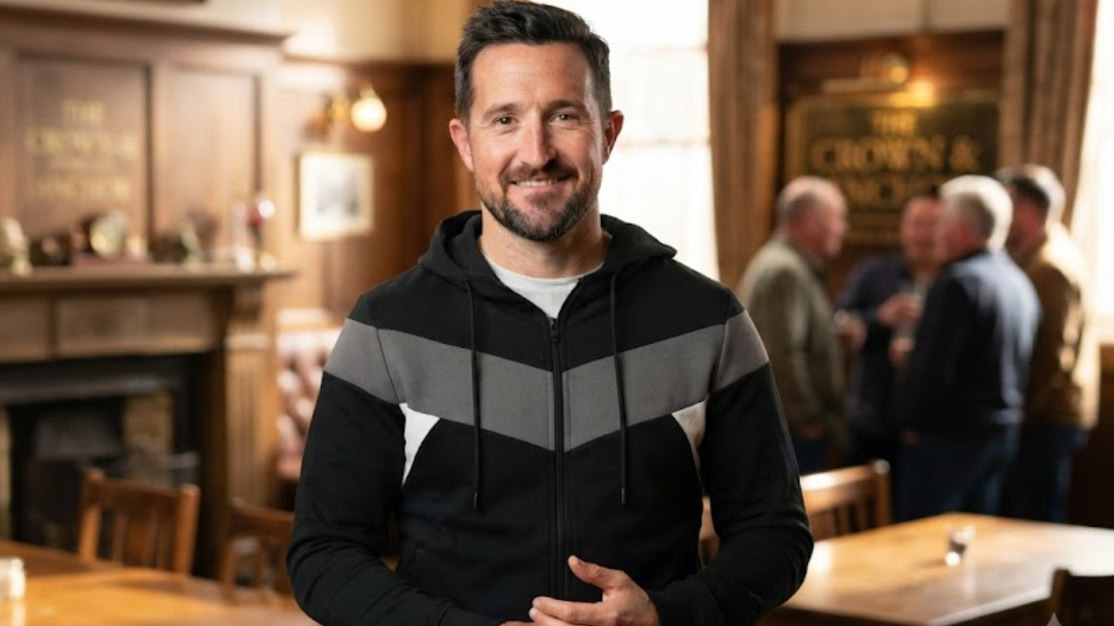 Emmerdale August 2025 LUKE 1977 Black Baldur Zip-Up Hoodie with Grey Chevron Panel