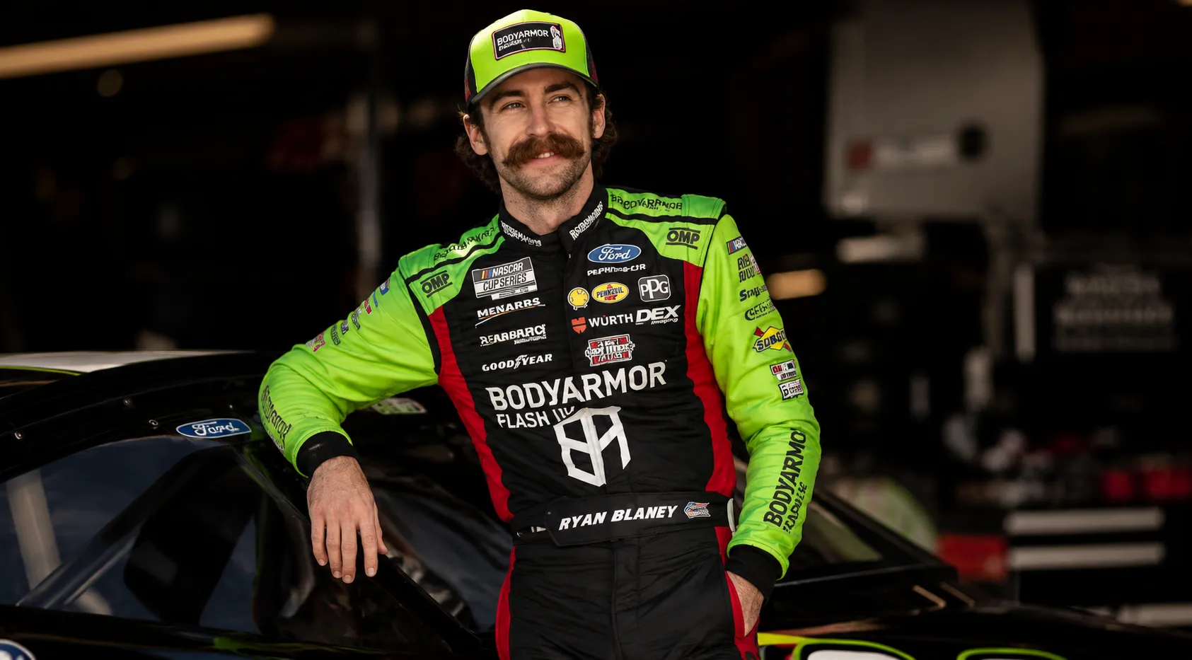 Ryan Blaney NASCAR Cup Series Quaker State 400 Black and Green Racing Jumpsuit with Neon Green Sleeves and Sponsor Logos