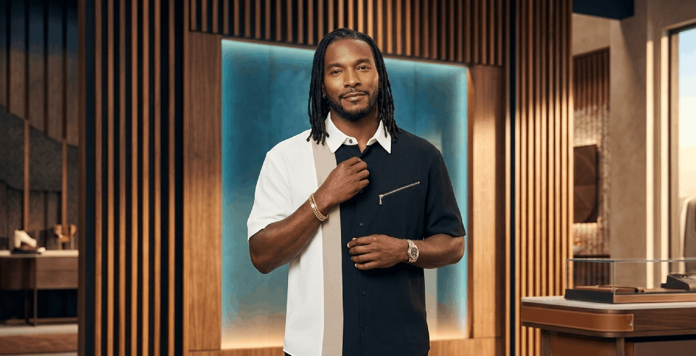 Scott Evans wearing black cream taupe colorblock shirt on Access Hollywood 2025 with geometric panel design and zipper pocket