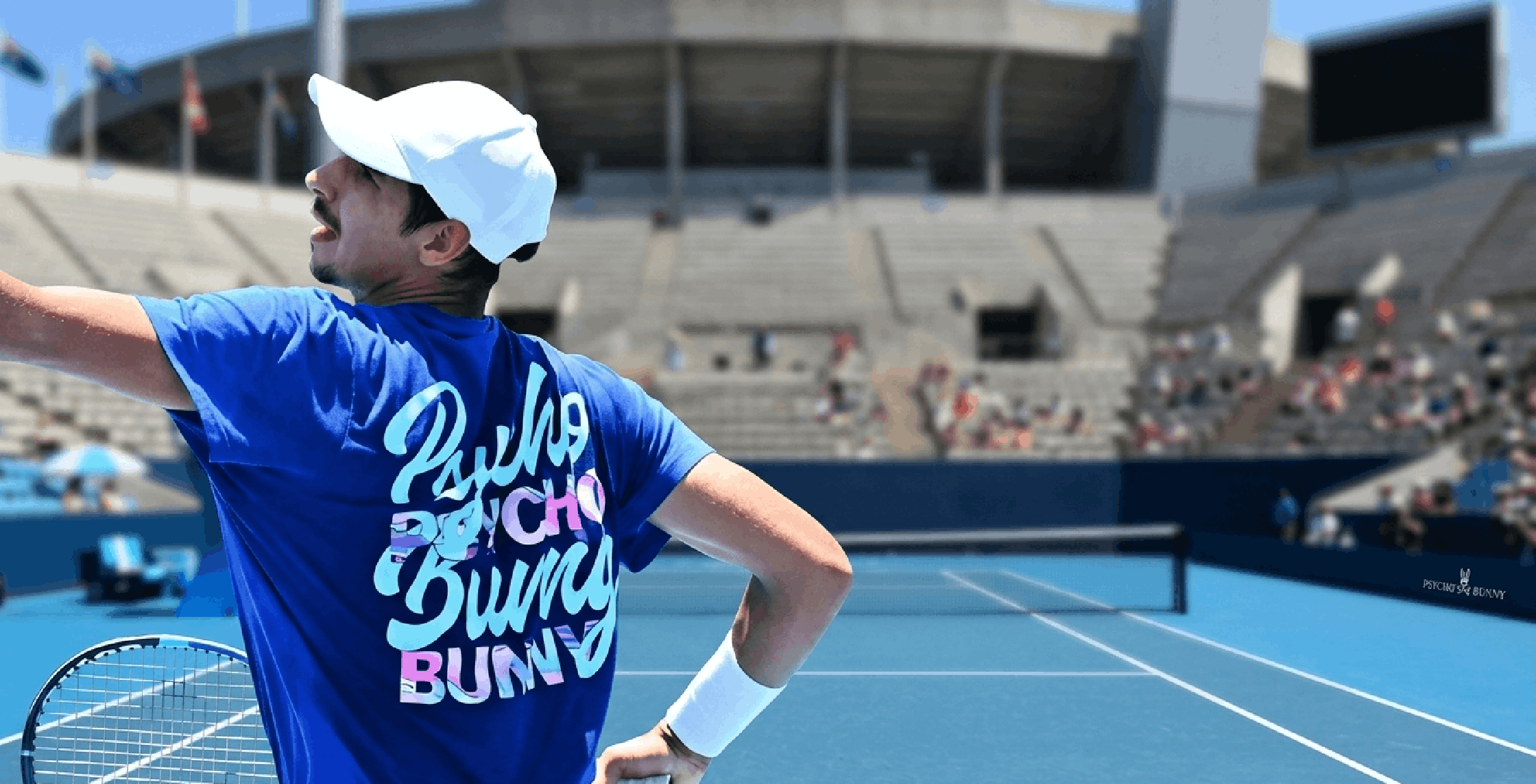 Alexei Popyrin Brisbane International 2026 blue Psycho Bunny performance T-shirt with skull and crossbones graphic