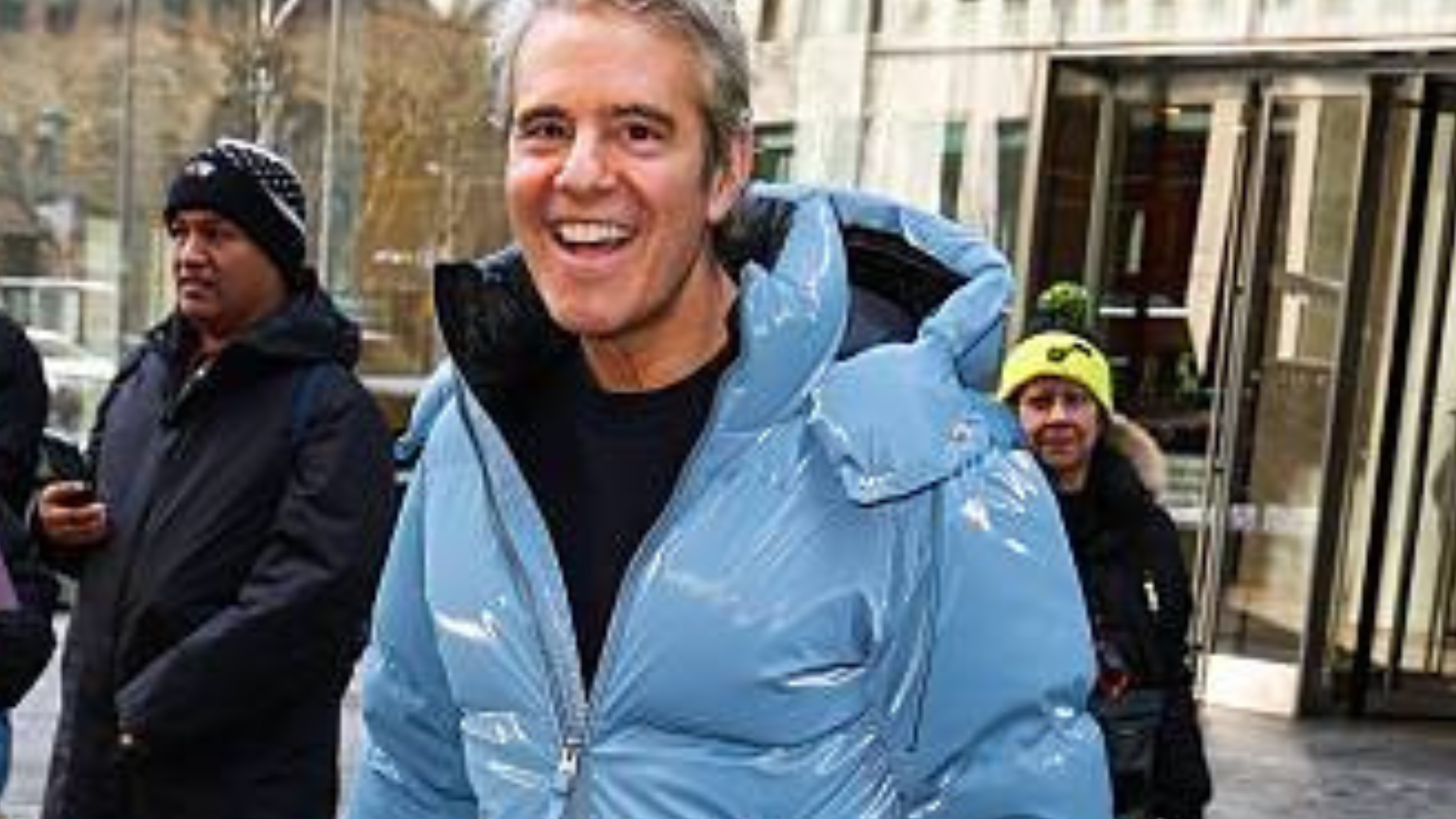 Andy Cohen wearing glossy provincial blue puffer jacket outside SiriusXM Studios in New York City 2026