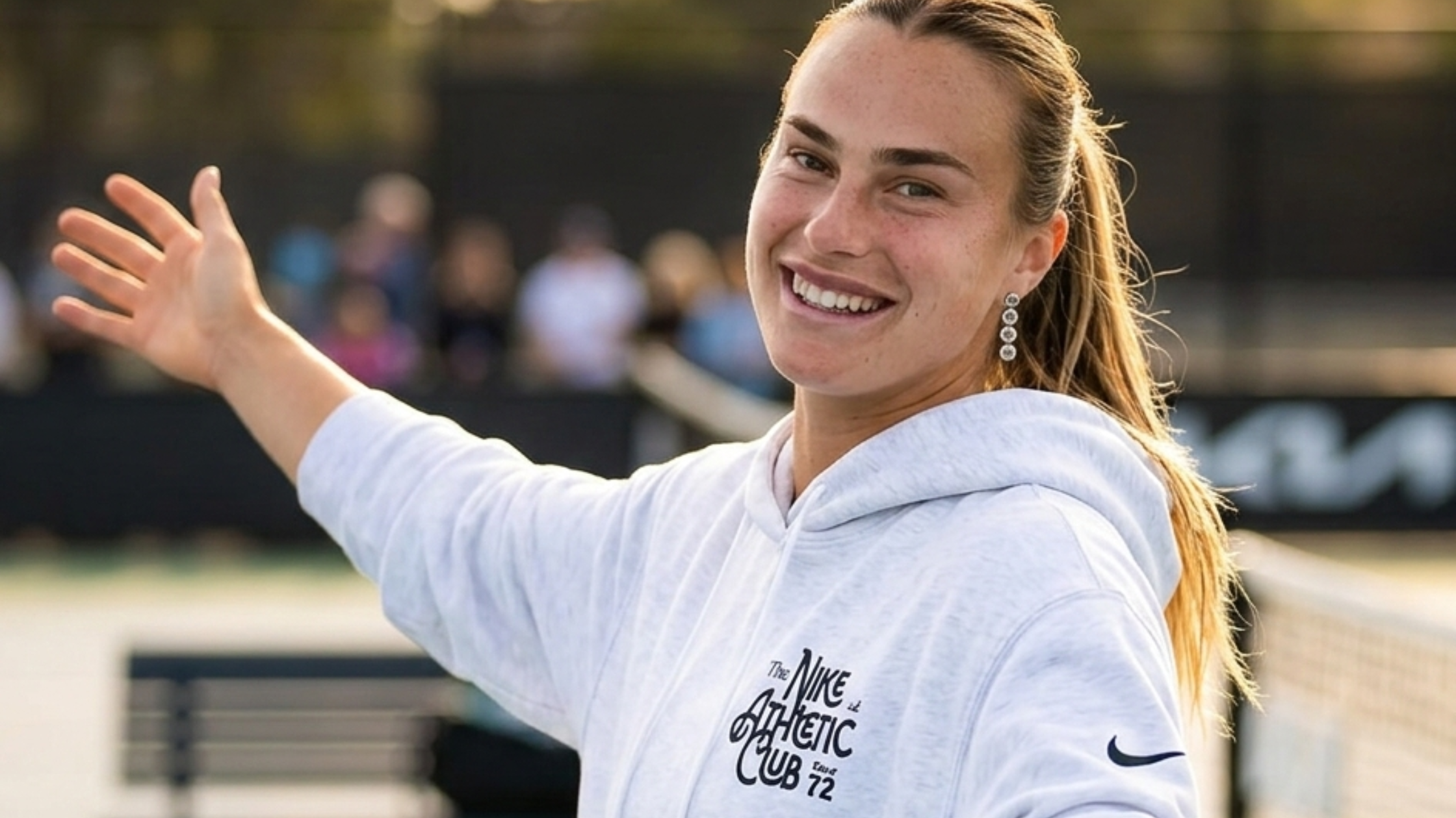 Aryna Sabalenka wearing light grey Nike Athletic Club oversized hoodie with Australian Open 2026 graphics