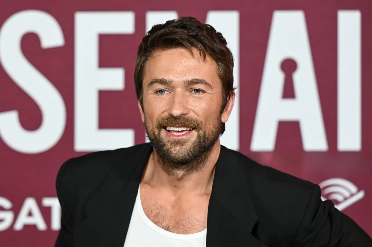 Brandon Sklenar wears a structured black blazer with a white tank top at The Housemaid premiere, showcasing rugged elegance and modern tailoring.