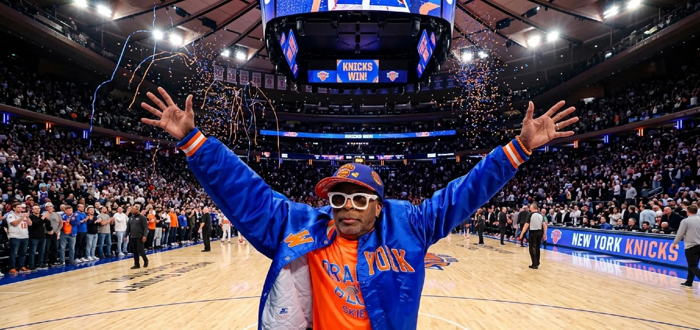 Spike Lee New York Knicks blue satin varsity jacket with orange NEW YORK appliqué NBA playoffs courtside style