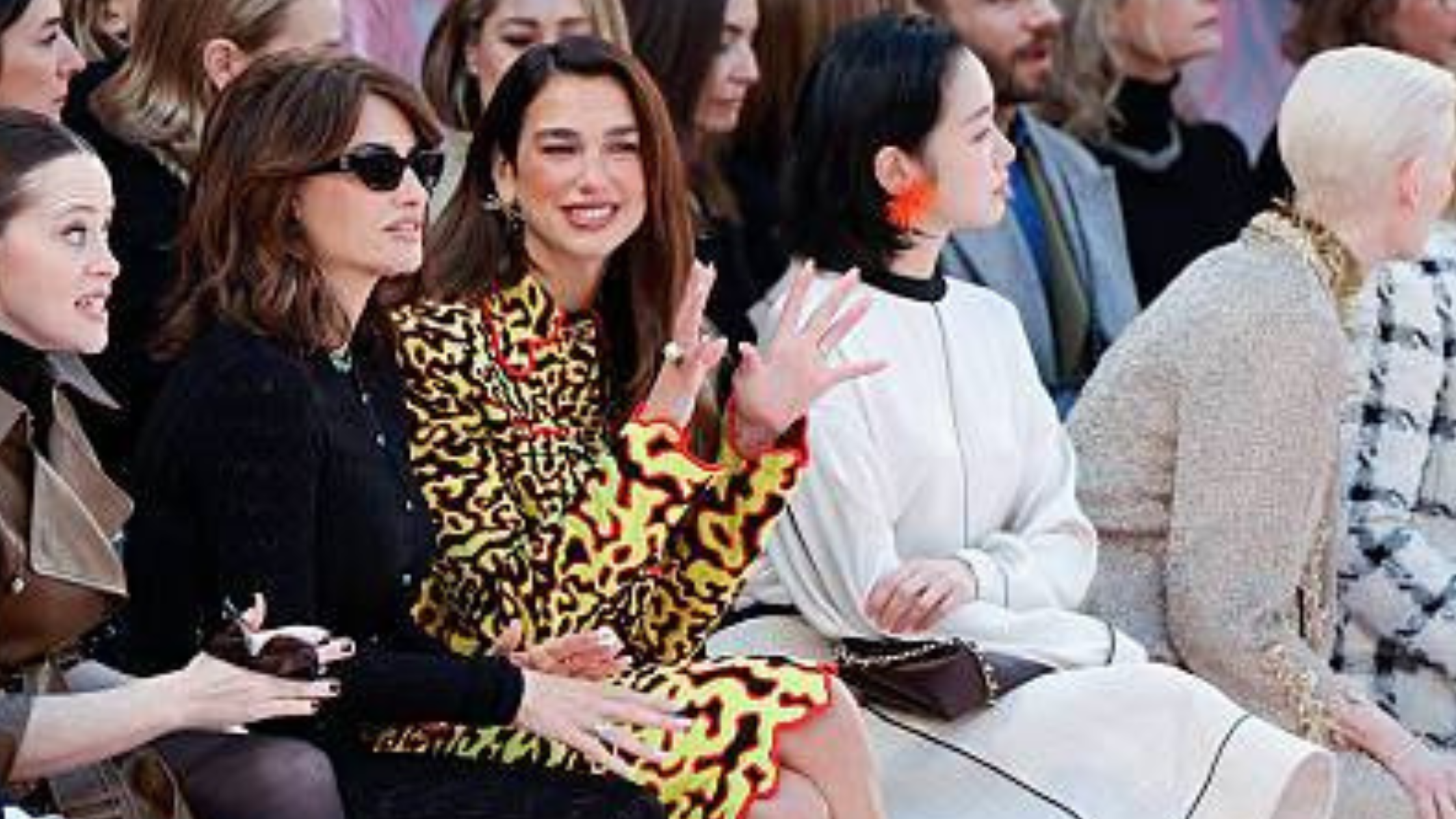 Chanel Haute Couture star Dua Lipa wears a bold yellow and black animal-print couture jacket, adding vibrant drama to Paris Fashion Week.