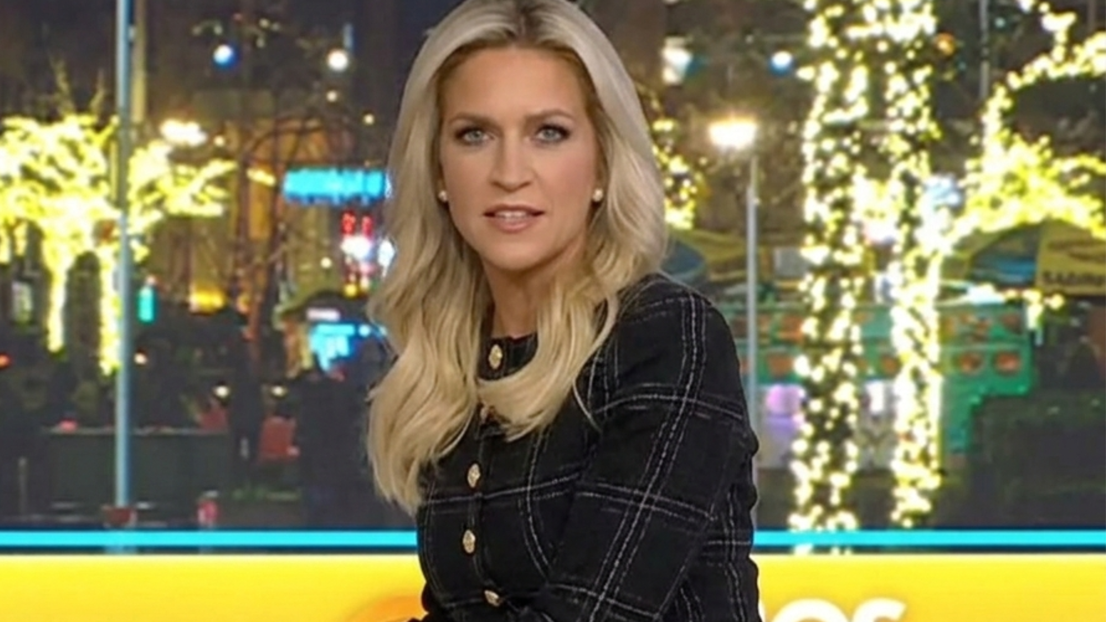 Fox and Friends star Ainsley Earhardt wears a stylish black plaid jacket, adding a pop of elegance to the studio set.