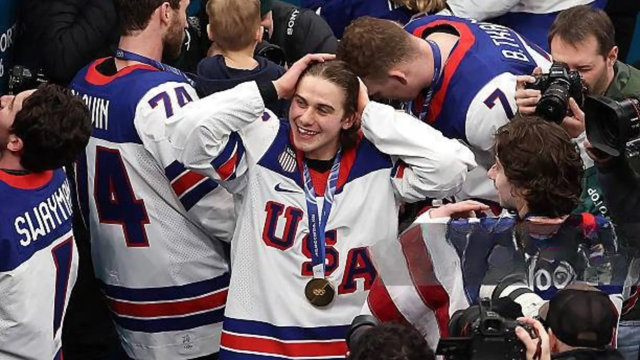 Jack Hughes wearing Team USA 2026 Milan Cortina Olympic ice hockey jersey in white with red and navy accents