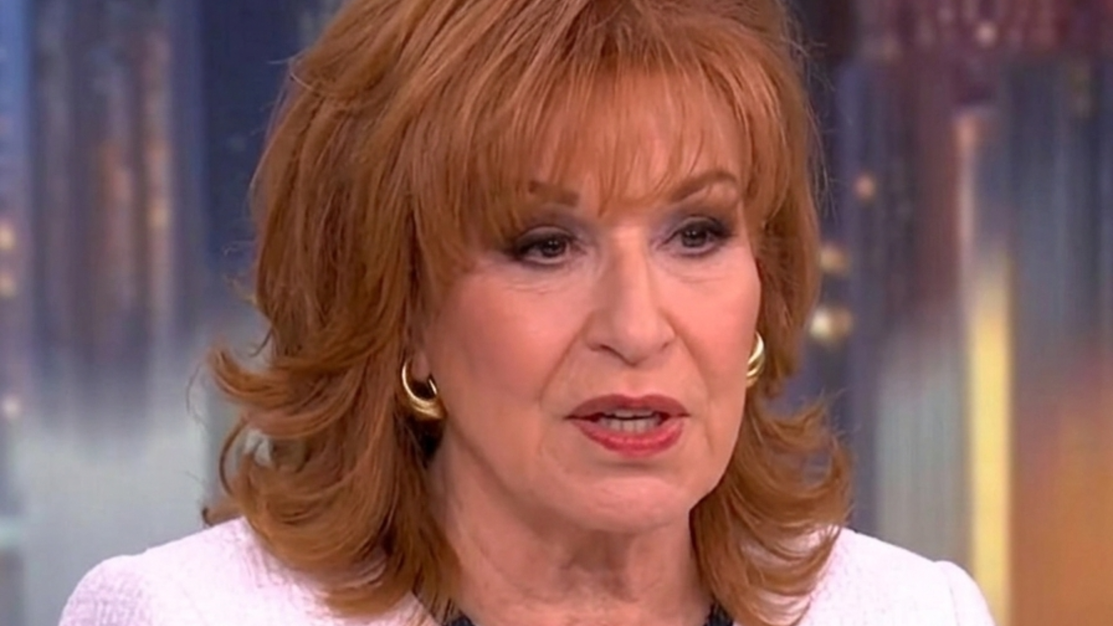 Joy Behar wearing a white tweed contrast trim jacket with black braided detailing and gold buttons on The View May 21, 2025 episode