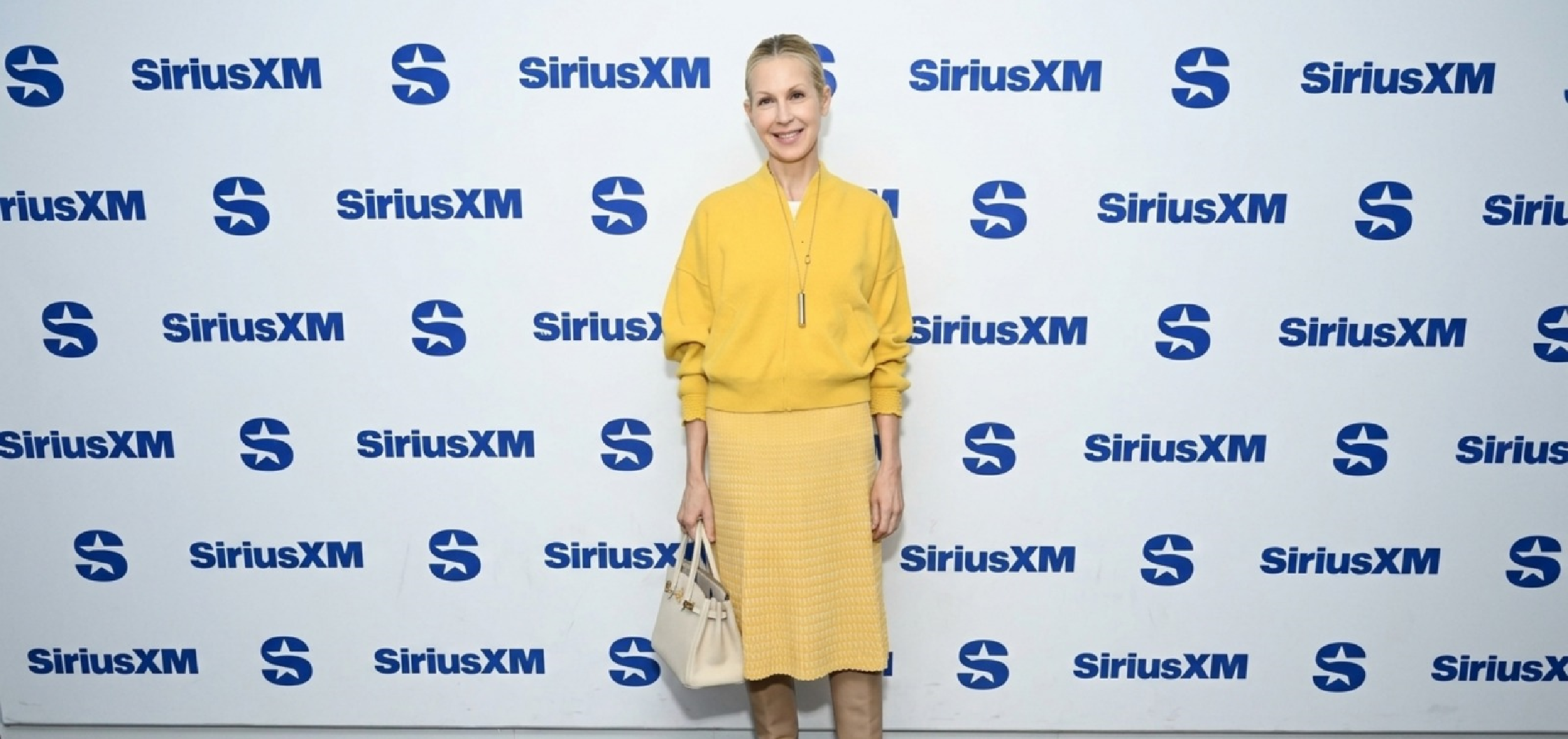 Kelly Rutherford saffron yellow cropped bomber jacket at SiriusXM Studios NYC 2026
