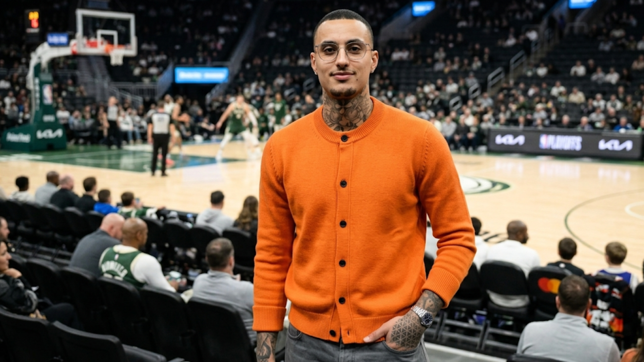 Kyle Kuzma NYC 2026 orange ribbed crewneck cardigan with black button closure and slim straight fit