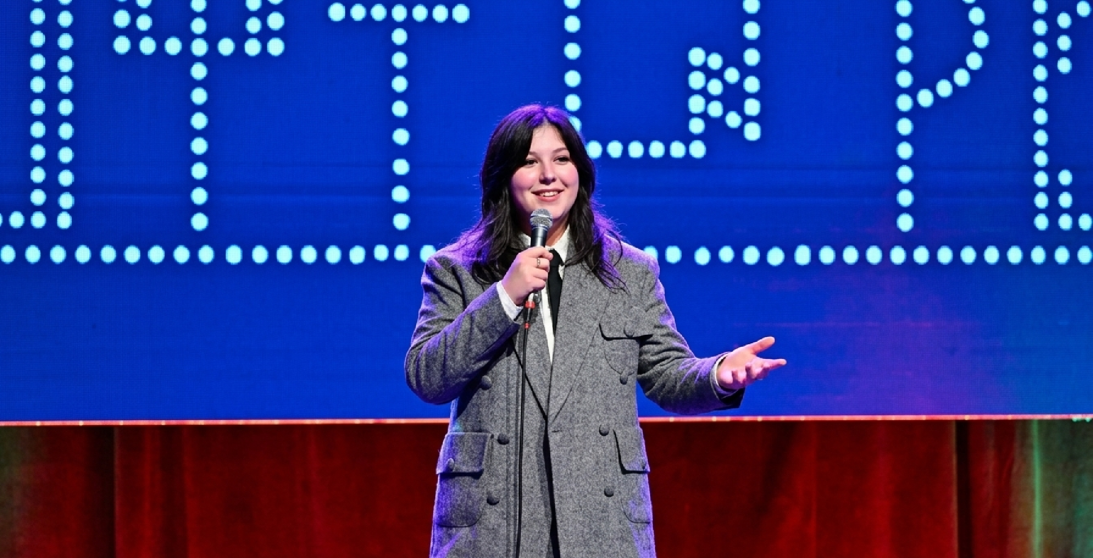 Lucy Dacus wearing oversized grey tweed blazer with notch lapels and large flap pockets at 2025 New Yorker Festival