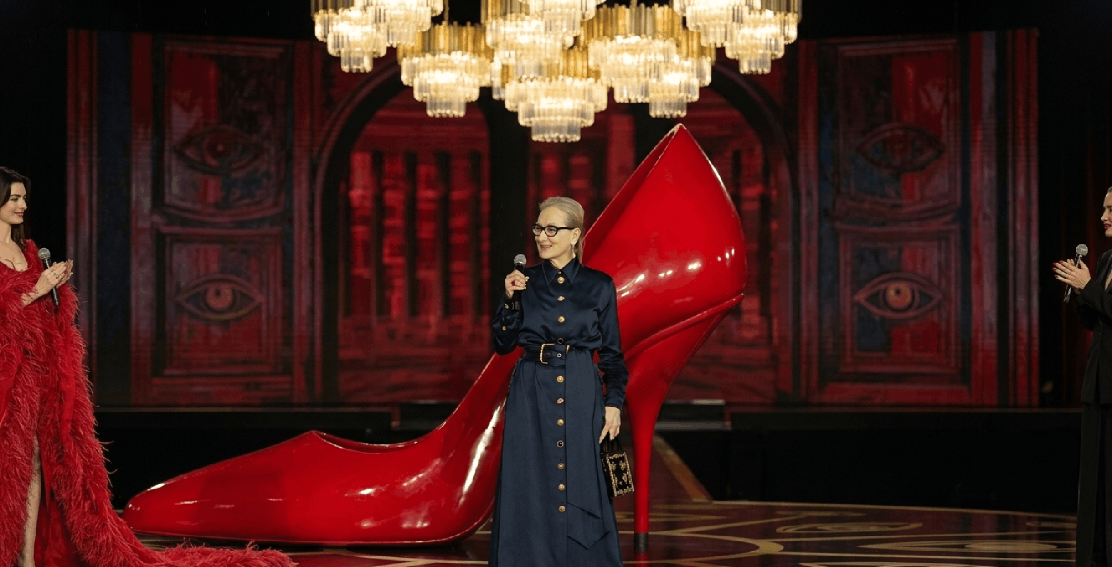 Meryl Streep The Devil Wears Prada 2 2026 long navy coat with gold surrealist buttons and cinched waist