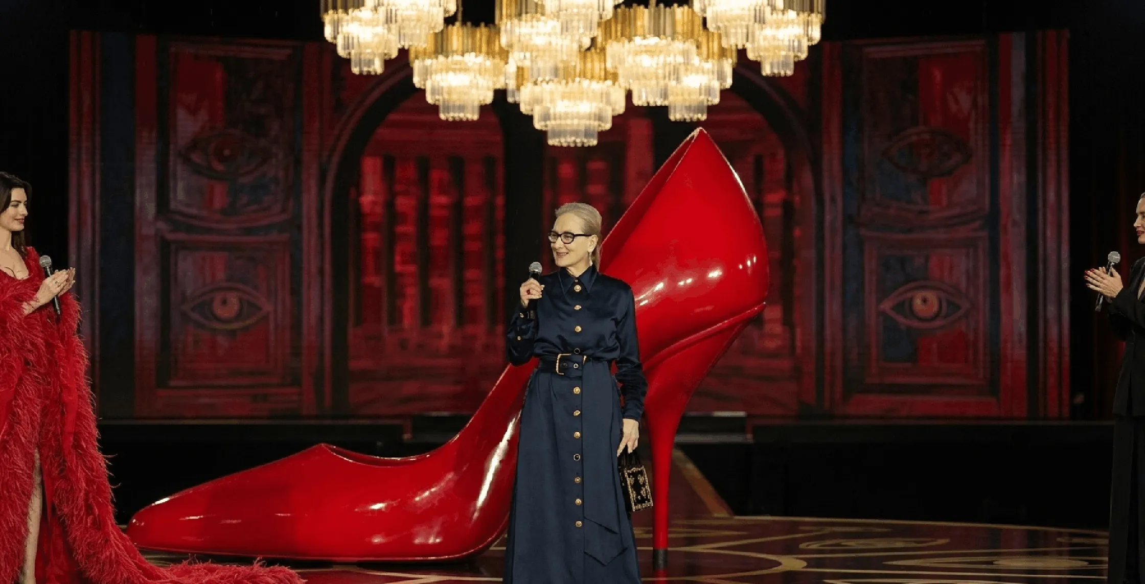 Meryl Streep The Devil Wears Prada 2 2026 long navy coat with gold surrealist buttons and cinched waist