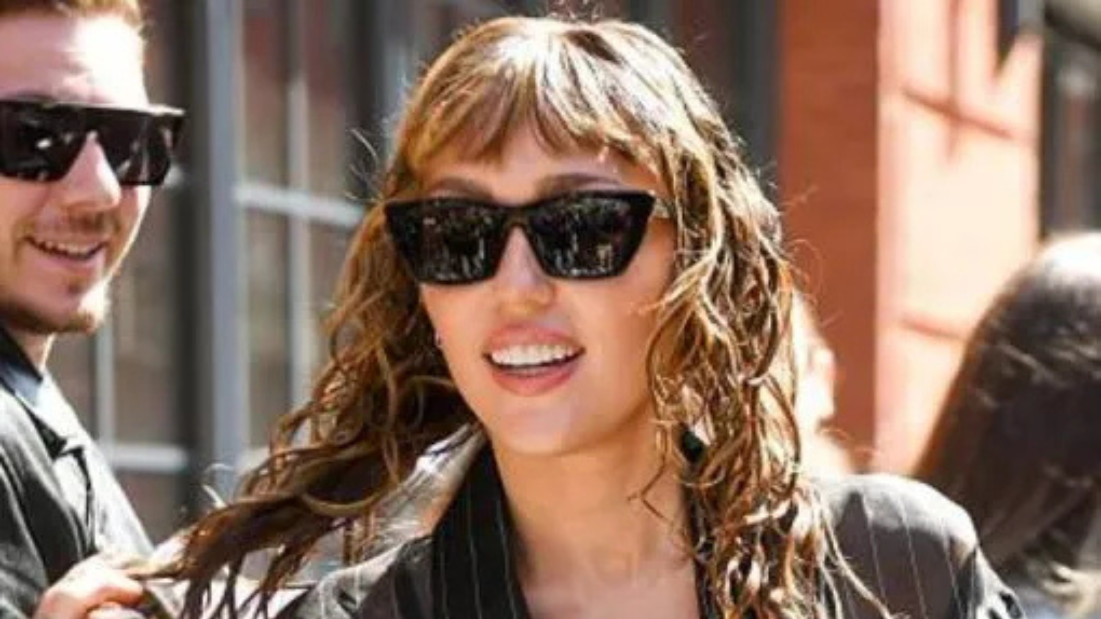 Miley Cyrus NYC 2025 wears a stylish black sheer pinstripe shirt, adding chic street-style flair to the photoshoot