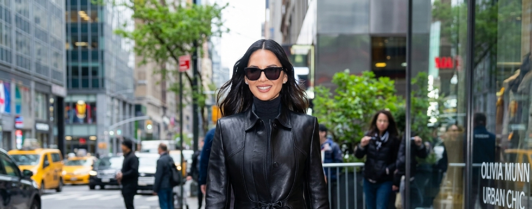 Olivia Munn Midtown NYC 2025 black leather long trench coat with belted waist and structured seams