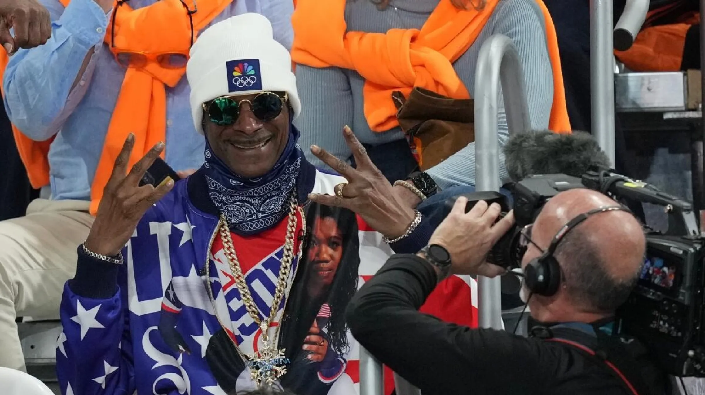Stark white Moschino x Snoop Dogg ‘Young, Wild &amp; Free’ hoodie featuring a freestyle skier, light blue bandana pattern, and crimson logo, inspired by the 2026 Winter Games.