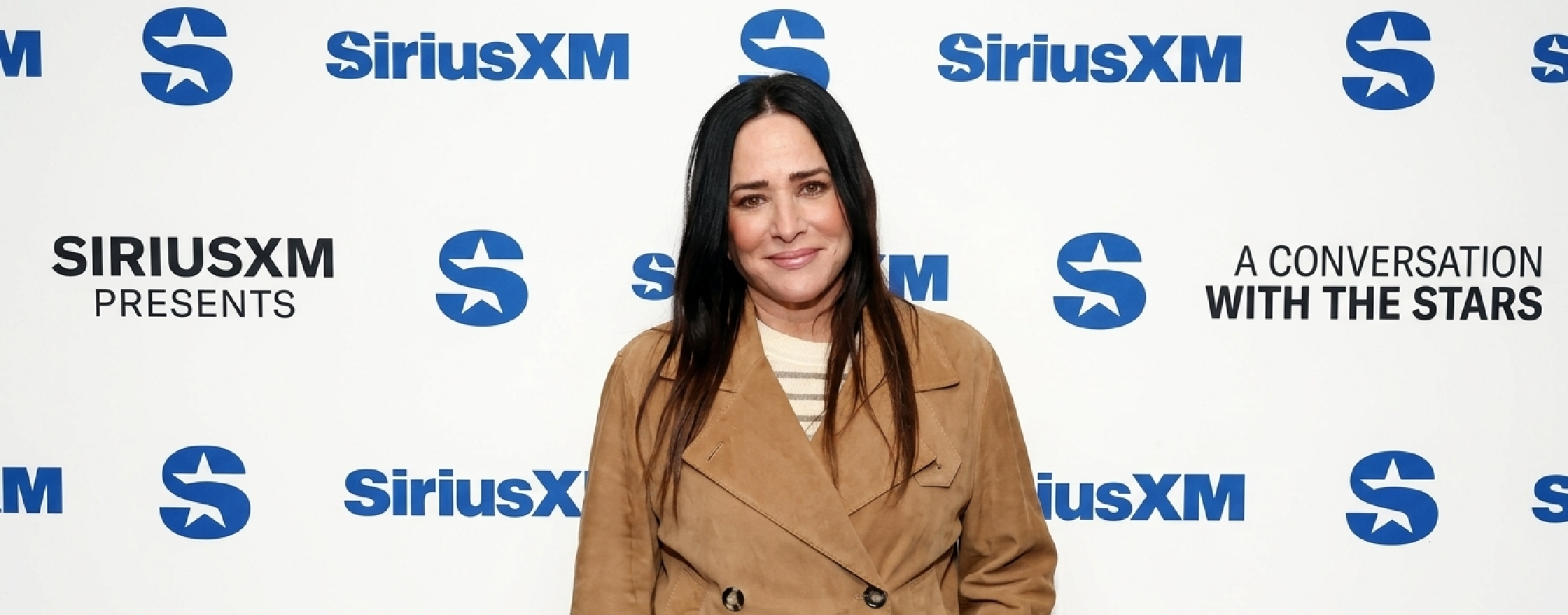 Pamela Adlon SiriusXM Studios 2025 brown suede double-breasted jacket with wide lapels and relaxed fit
