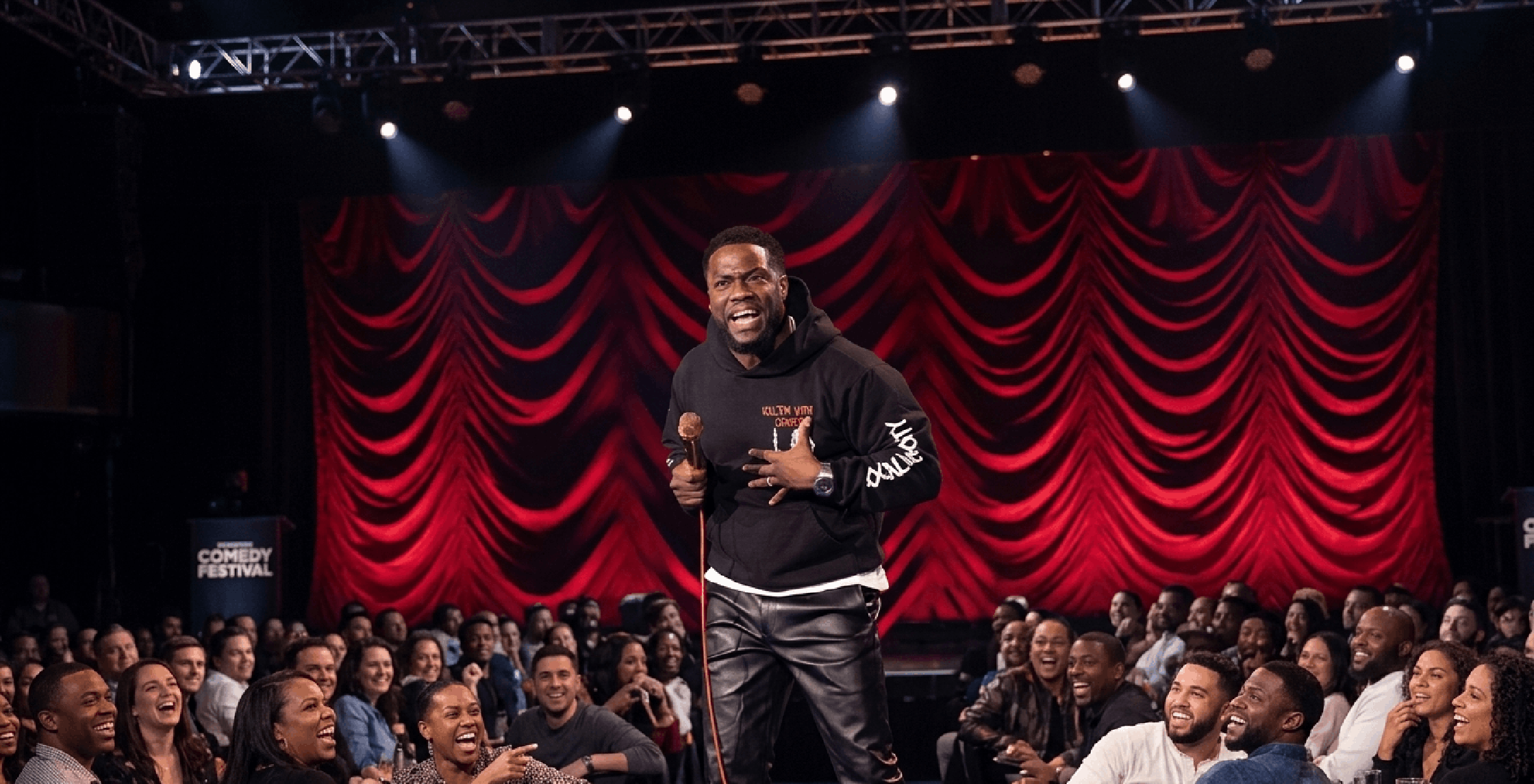 Reality Check Kevin Hart black hoodie with gothic skull graphics, red â€œKill ’Em With Comedyâ€ text, tour-inspired streetwear design, front view