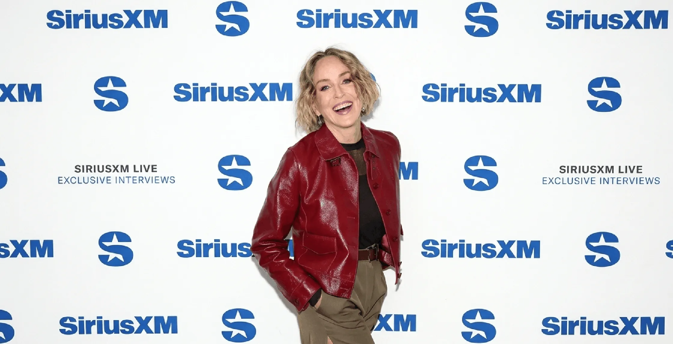 Sharon Stone wearing cherry red patent leather jacket at SiriusXM Studios 2026 in New York City