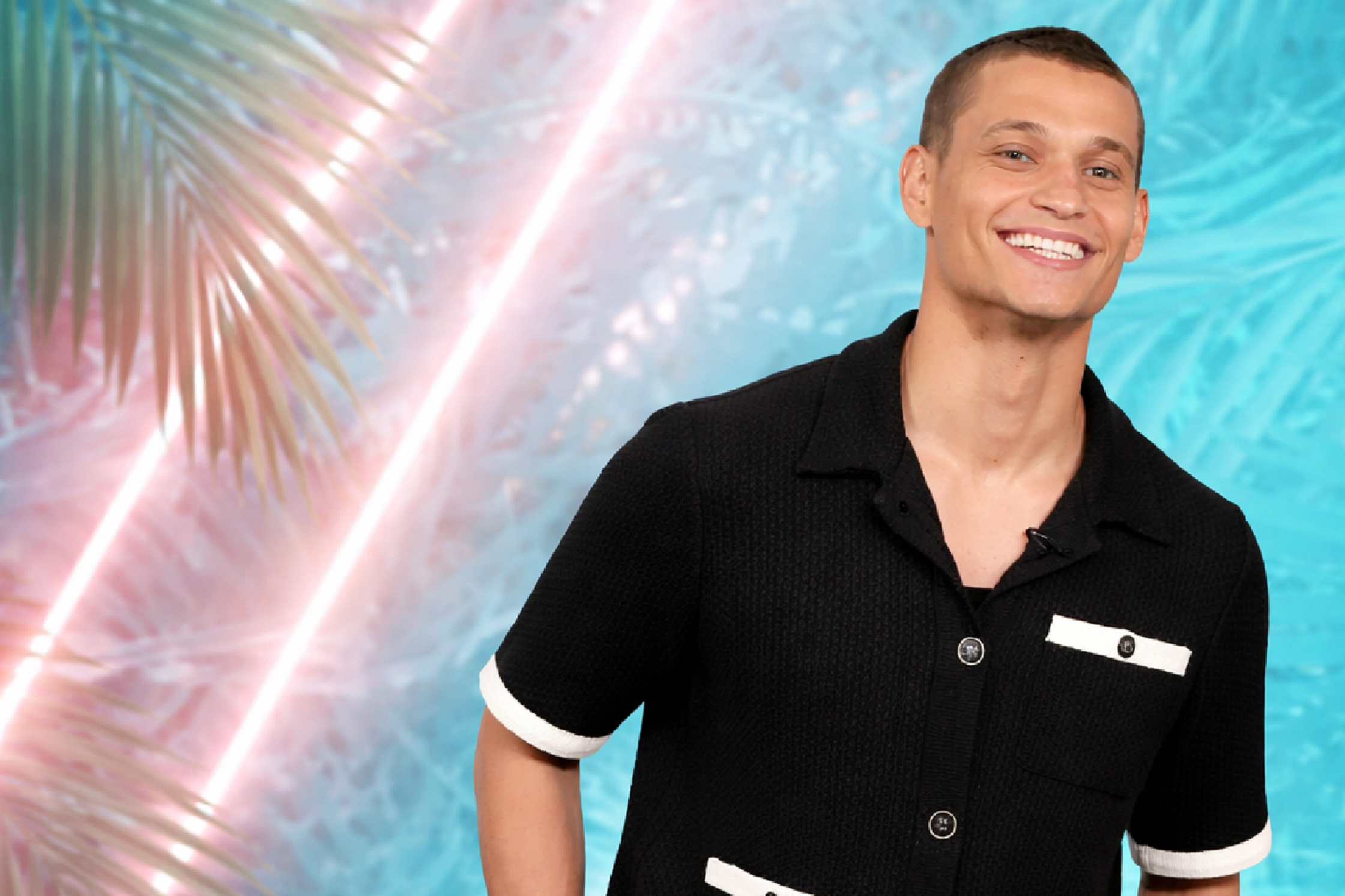 Tyriq Withers wearing a black polo cardigan with white contrast detailing on The Jennifer Hudson Show Season 4