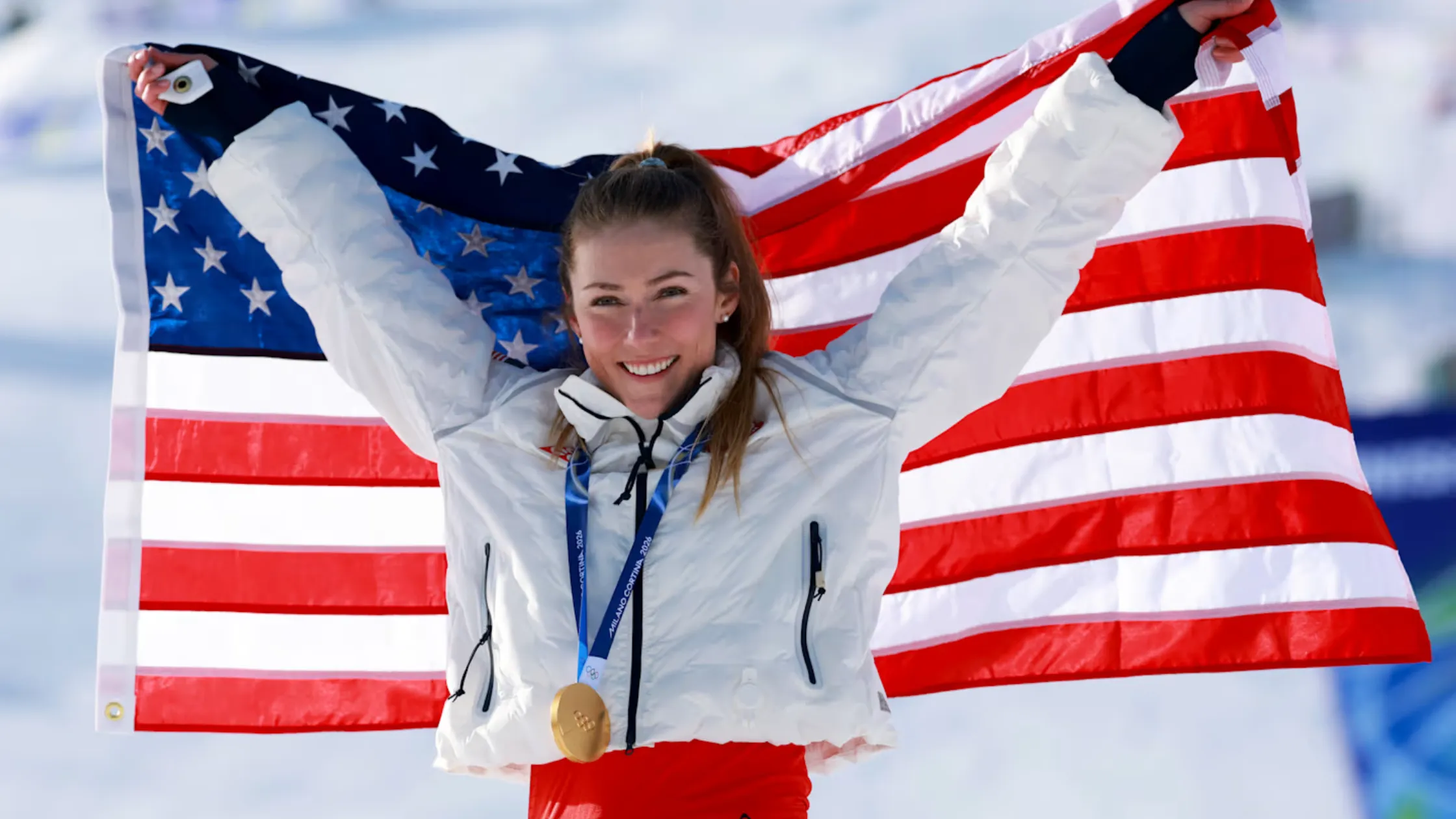 Winter Olympics 2026 star Mikaela Shiffrin wears a stylish white puffer jacket, adding a chic touch to her Alpine skiing gold performance.